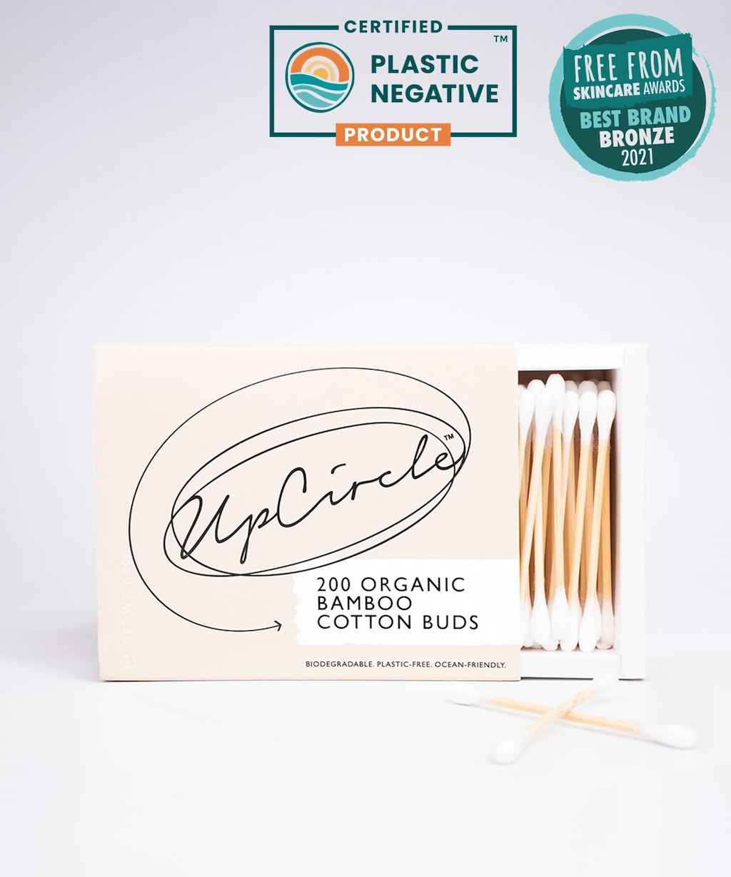 Upcircle Organic Bamboo Cotton Buds. Plastic free buds. The box of 200 is shown slid open with some of the buds showing. Badges saying it is a certified plastic negative produce and a Bronze in the Free From awards are shown.