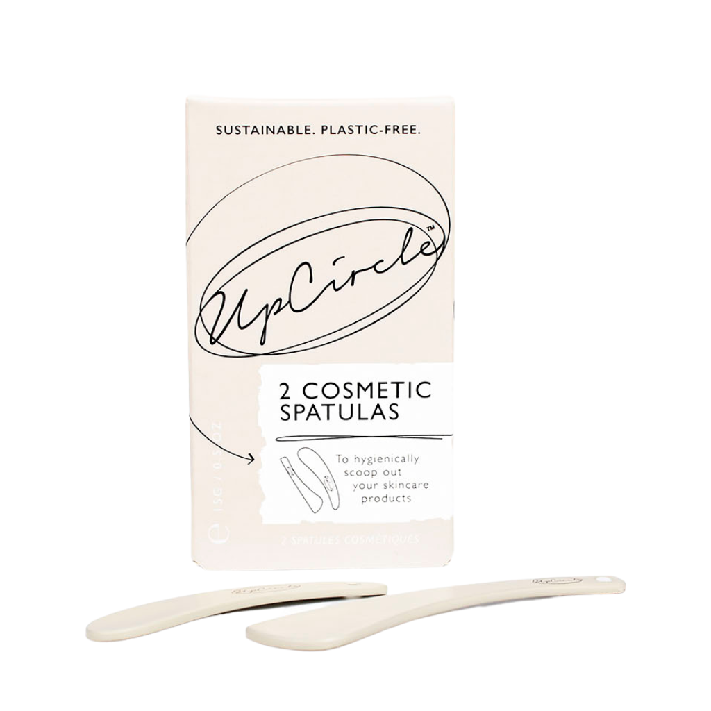 Upcircle Cosmetic Spatulas. Plastic free beauty accessories. The spatulas are sitting in front of the beige paper box they come in, with the cursive Upcircle logo on the box.