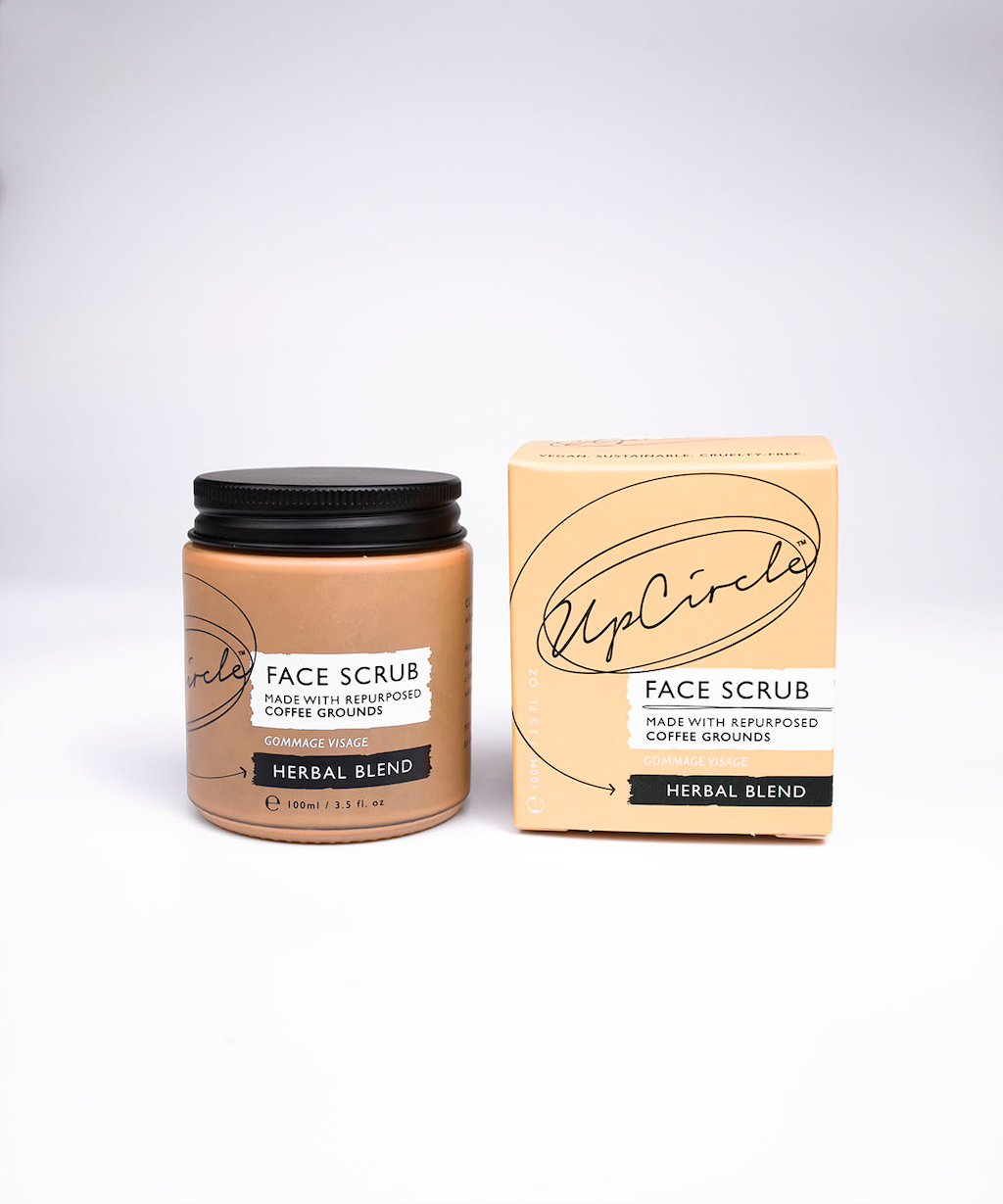 upcircle skincare herbal blend coffee face scrub on a white background. on the left is the glass jar and the box is on the right